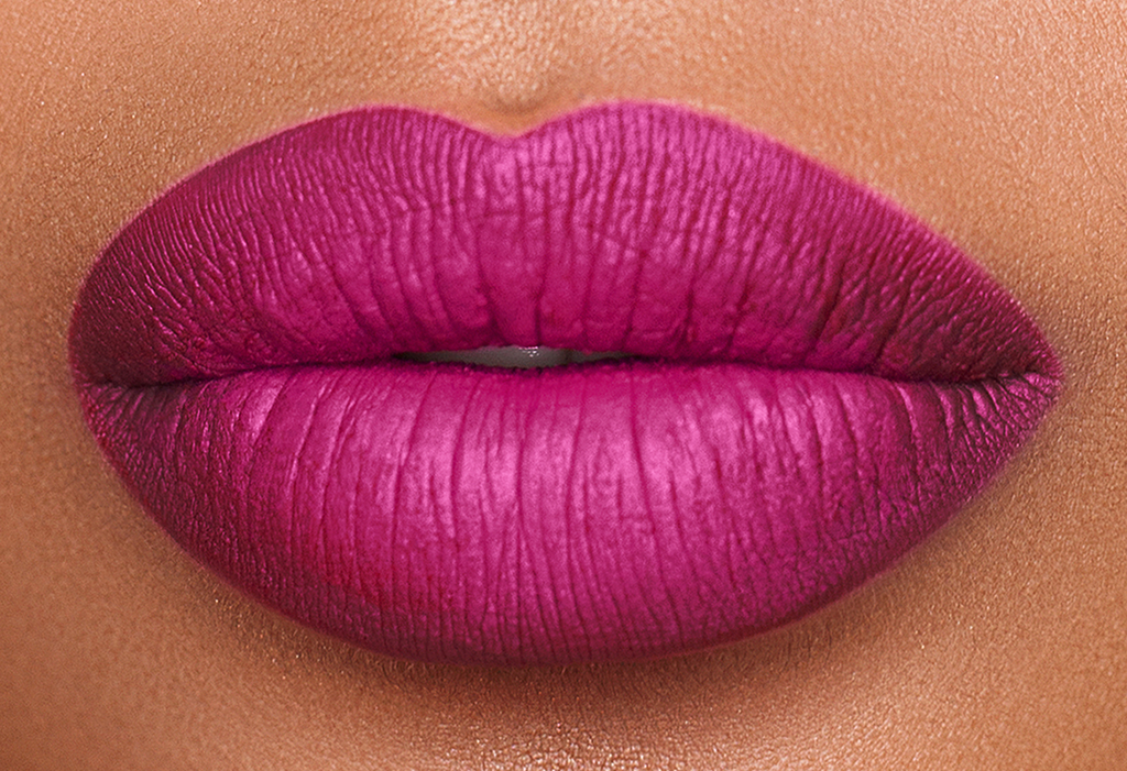 lips with magenta colored lipstick.  Matte texture finish.