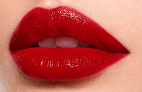 Lips with red colored lipstick, luster textured finish.