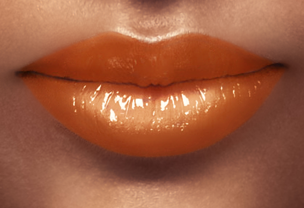 Lips with gold lipgloss and shinny texture.